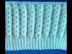 the side of a knitted blanket with white lines on it and blue background,