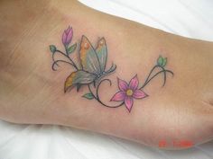 a small tattoo on the foot of a woman