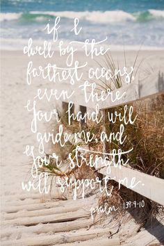 a wooden bench sitting on top of a sandy beach next to the ocean with a bible verse written above it