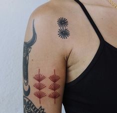 a woman with a tattoo on her arm and an ox skull in the middle of it