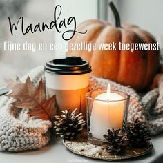 a candle and some pine cones on a window sill with the words mandelg written in german