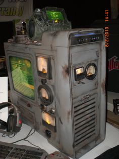 an old tv sitting on top of a desk next to a keyboard and mouses