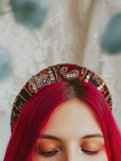 Crimson Rhapsody Tiara is a beautiful patchwork crown made from upcycled materials. It is made in a beautiful red and burgundy colors with patches of paisley fabric and intricate golden beading. Design is inspired by bohemian and hippie styles with the nostalgic 70s vibe.

Maylina Soul crowns are made with extra comfort and care in mind. They are extremely lightweight and bend exactly to the shape of your head so you can wear it all day and completely forget that you have it on. Perfect solution for people with sensitive heads who still want to add a beautiful tiara to their outfit. Thanks to elastic lace tie it is one size that truly fits everybody and stays securely on your head. Adjust the tie to fit, if needed and either hide it beneath a strand of hair or let it hang as an addition to Fabric Crowns, Boho Tiara, Red Satin Fabric, Hippie Styles, Hippie Headband, Handmade Crown, Strand Of Hair, Fabric Crown, Hippie Headbands