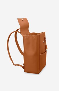 A chic and ultra-spacious office companion to refine your work-from-anywhere style. The Large Soft Backpack, handcrafted entirely from full-grain European leather, reimagines The Mini Soft Backpack with enhanced storage capability and increased all-day comfort. Featuring magnetic closure, a padded laptop sleeve to secure devices up to 16" and priority and zipped pockets to house valuables, the elegant carryall caters to every professional need. Crafted entirely from full grain sustainable DriTan Classic Cognac Backpack For Travel, Classic Cognac Travel Backpack, Classic Satchel Backpack For Work, Luxury Leather Satchel Backpack For Work, Brown Leather Backpack For Work, Chic Leather Backpack For Business, Classic Workwear Satchel Backpack, Rectangular Leather Backpack With Adjustable Strap For Work, Modern Rectangular Leather Backpack For Work