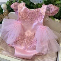 Pink Glow Tutu Romper Our pink glow tutu romper is the perfect outfit for that special day, that special celebration, and or any special occasion. Handmade with lots of love! This tutu romper features multi-layered tutu that cascades down from the back. With gorgeous satin flutter ruffle sleeves and intricate sequin floral details on the bodice. The sequin top is a halter. The neck ties help you adjust to the desired length. It is lined to prevent scratching. Birthday girl romper, First Birthday Spring Party Bubble Romper With Ruffles, Fitted Pink Bubble Romper For Party, Party Ballet Tutu Dress With Ruffles, Fitted Pink Bubble Romper For Baptism, Elegant Pink Tutu Dress For First Birthday, Pink Ballet Dress For Party, Pink Ballet Style Party Dress, Pink Ballet Dress With Ruffles, Pink Ruffled Tutu Dress For Party