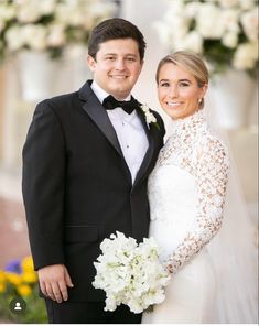 a bride and groom pose for a wedding photo