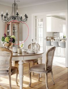 a dining room table with chairs and a chandelier