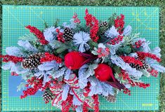 a bouquet of red flowers sitting on top of a green mat