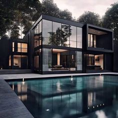 a modern house with pool in the foreground and trees in the backgroud