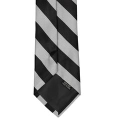 From everyday to a special occasion, this black and silver striped tie is a stand-out choice. Whether you're lucky enough to have it as your school or team colors, or just like the classic combination of black and silver, this tie will have you looking put together with little effort on your part. Add it to a black suit for a quick and easy formal look, or black slacks and a white button down for a more casual feel. From graduation to a uniform, this tie fits the bill! As far as the specifics, t Staff Uniforms, Silver Tie, Student Body, Black Slacks, Striped Tie, Formal Looks, Black Suits, Tall Guys, Silver Man