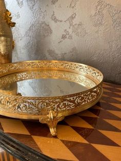 two golden trays sitting on top of a checkered table