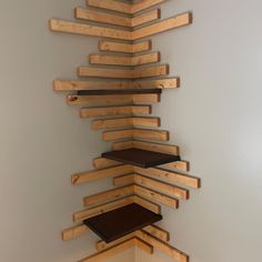 a room with some shelves made out of wooden planks and one shelf is stacked on top of the other