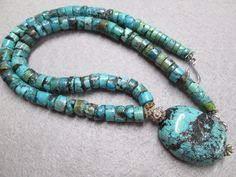 "A beautiful Southwestern hand crafted genuine turquoise necklace. Handsome heishi shaped turquoise beads form the 18\" long necklace....gorgeous blues with hints of green and chocolate color matrix. I know all you women will love this one, but it's perfect for a guy too! The heishi are about 9mm wide, with an outrageous large blue turquoise stone hanging from the center. The colors are wonderful, like that of the famous Kingman Mine. A beautiful piece, one with which you'll receive many a compl J Necklace, Heishi Necklace, Jewelry Turquoise, Necklace Tutorial, Real Turquoise, Necklace Turquoise, Southwestern Jewelry, Chocolate Color, Jewelry Armoire