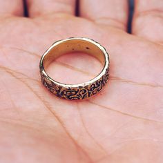 Indonesian Balinese script writing on a rugged band in a gold toned glossy brass. Bali was first inhabited around 2000 BC and has a rich culture rooted in spiritual beliefs. Available in 925 Sterling Silver https://etsy.me/2VrKBy2 Ring Size Available in all sizes. Please be sure to find your exact ring size for the finger you want before ordering. See image chart above or you can use the chart on my website as a guide - https://jewelrylab.co/pages/ring-sizing-tips A note about brass jewelry and Gold Brass Engraved Ring For Promise, Brass Engraved Ring For Promise, Antique Engraved Open Metal Ring, Bronze Brass Rings For Anniversary, Anniversary Bronze Brass Ring, Yellow Gold Brass Engraved Ring For Promise, Antique Finish Gold Rings For Anniversary, Gold Rings With Antique Finish For Anniversary, Vintage Gold Engraved Ring, Hand Forged