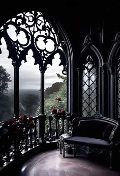 an ornate balcony with black furniture and red roses in the vases on the windowsill