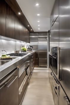 Modern, sleek kitchen with stainless steel appliances and dark wood cabinets. The Galley Sink Workstation, Wood Galley Kitchen, The Galley Workstation Sink