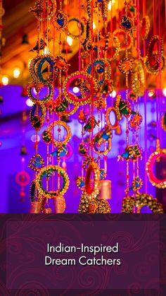 an elaborate chandelier hanging from the ceiling in a room with purple lighting and decorations