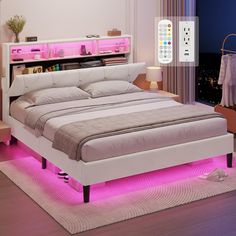 a bed with pink lights underneath it and a remote control on the wall next to it