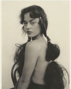 a black and white photo of a woman with long hair