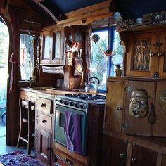 a kitchen with an oven, stove and cupboards in it's center area