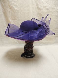 Vintage Purple Red Hat Society in Wool and Tulle with Sequins. This is a vintage Red wool hat society hat and is one size fits all. A beautiful purple floppy hat with brim turned up in the front, decorated with purple tulle, a purple sequined applique and tiny sequined at the end of each bough of tulle. The Red Hat Society is an international social organization that was founded in 1998 in the United States for women age 50 and beyond, but now open to women of all ages. Its main purpose is to pr Vintage Wide Brim Top Hat For Party, Summer Wide Brim Purple Costume Hat, Summer Purple Wide Brim Costume Hat, Purple Mini Hats For Church And Kentucky Derby, Adjustable Purple Costume Hats And Headpieces For Church, Purple Wide Brim Summer Costume Hat, Purple Brimmed Mini Hat For Church, Elegant Party Hat, Adjustable Purple Top Hat For Kentucky Derby