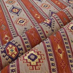 an orange and blue rug with many different designs on it's sides, in close up