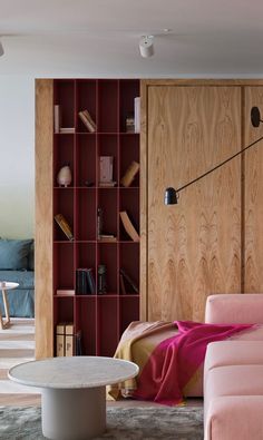 a living room filled with furniture and bookshelves next to a couch in front of a book shelf