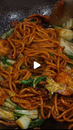 stir fry with noodles and vegetables being cooked in a wok