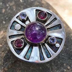 "Amethyst, Rhodolite Garnet and Iolite set in Sterling Silver. Oxidized Geometric Design. Just over 1\" in Diameter. Size 8, we have other sizes available, please inquire." Green Amethyst Ring, Medicine Wheel, Silver Necklace Statement, Coin Pearls, Rhodolite Garnet, Rings Cool, Green Amethyst, Topaz Ring, Amethyst Ring