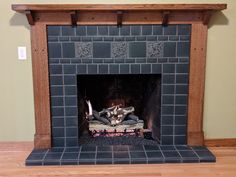 a fire place in a living room with wood and tile on the fireplace mantel