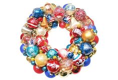 a christmas ornament wreath is shown on a white background with red, white and blue ornaments