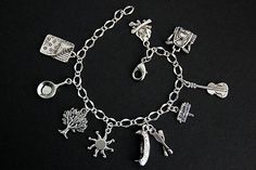 A collection of silver plated camping themed charms have been dispersed around a shimmering silver plated bracelet chain in this handmade charm bracelet. This camping charm bracelet is then completed with a lobster clasp and a 1/2 inch of chain at the end for adjustable sizing. Charms in this bracelet include a sleeping bag charm, pan charm, tree charm, sun charm, canoe charm with oars charm, camp sign charm, guitar charm, backpack charm, and campfire charm. ● Sizing ● To determine your bracelet Themed Sterling Silver Charm Bracelet Nickel Free, Handmade Themed Silver Charm Bracelet, Themed Nickel-free Sterling Silver Charm Bracelet, Handmade Symbolic Silver Charm Bracelet, Symbolic Handmade Silver Charm Bracelet, Handmade Themed Silver Bracelet, Handmade Charm Bracelets, Bracelet Summer, Camping Signs