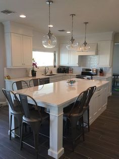 a large kitchen with an island in the middle