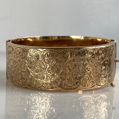 "Details: Sweet Victorian 9K gold bracelet. Lovely delicate floral engraving pattern along the front, smooth rose gold back. It has a very secure clasp. The bracelet opens wide and freely which makes it very easy to put on and wear. There are hallmark markings along the inside of the piece read \"S & P\", 9, 375, G' and has a little scale icon (see photo). The piece stamped 9K. and has a hand engraved serial number. Measurements: The interior of the bracelet measures 7\", the width is 7/8\" African Bangles, Engraved Bangle Bracelet, Floral Engraving, Engraved Bangle, Floral Bracelet, Vintage Bangles, Wide Bracelet, Dope Jewelry, Gold Engraving