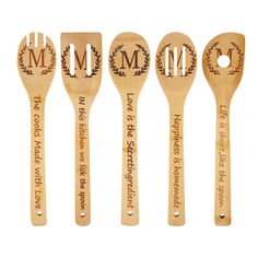 four wooden spoons with monogrammed designs are lined up next to each other