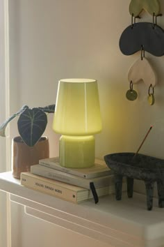 a lamp sitting on top of a white shelf