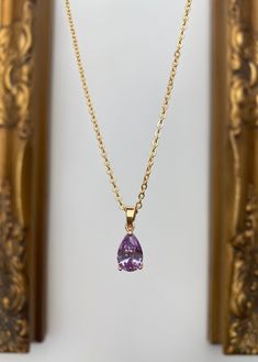 Gold-plated lilac teardrop jewel necklace. The blue teardrop jewel is set in a gold-plated frame measuring 1.2 cm x 0.8 cm. Hung on a gold-plated chain which measures 45.7 cm (18 inches). Comes in a black velvet cushioned box as seen in last photo. Free of charge. Matching earrings available here.... https://www.etsy.com/uk/listing/961868771/lilac-teardrop-jewel-huggie-hoop?ref=listing_published_alert INTERNATIONAL BUYERS please choose the tracking option if you would like your order to be track Gold Pear-shaped Drop Necklace With Gemstone, Elegant Lavender Teardrop Necklace, Lilac Necklace, Lilac Jewelry, Gold Necklace Wedding, Asymmetrical Earrings, Jewel Necklace, Gem Necklace, Fancy Bags