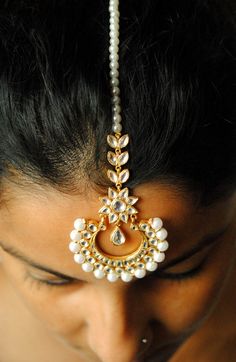 "A gorgeous cresent shaped centre piece, with kundan set stones adorned with imitation pearls. This handcrafted head gear is a must have style statement! * Stone : CZ (can me made in natural uncut flat diamonds as well. Please convo for quote) * Gold - 18k, 11 gms yellow gold * Centre piece : 2\" x 3.5\" approx * Total Length : 7.5 inches (including centre piece and hook) If you like this piece, please press \"Pin it\" button on the right of your screen. Find us on Instagram for exquisite design Maang Tikka Kundan, Forehead Jewelry, Pin It Button, Diamond Ear Cuff, Kundan Jewelry, Oval Diamond Engagement, Diamond Tiara, Maang Tikka, Head Gear