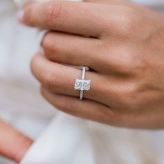 a person wearing a ring with a cross on it