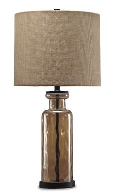 a glass lamp with a brown shade on it's base and a black base