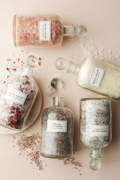 three bottles filled with different types of bath salts