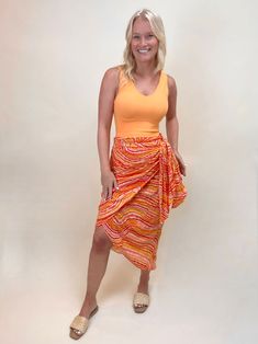 Bold orange printed maxi wrap skirt/sarong with a knot detail that can be worn at the front or towards the side. Unlined 100% Polyester Hand wash cold/ Line dry Recommended sizing: S(2-4) M(6-8) L(10-12) Maxi Wrap Skirt, Wrap Midi Skirt, Leaf Scarf, Sarong Wrap, Black Earrings Dangle, Denim Jewelry, Wrap Maxi Skirt, Scarf Top, Printed Wide Leg Pants