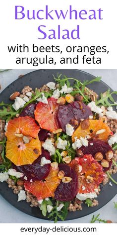 a black plate topped with beets, oranges and feta on top of a table