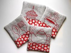 four red and white napkins with designs on them