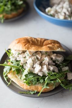 a sandwich with chicken salad on a black plate