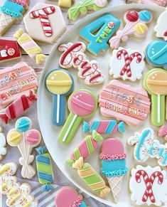 decorated cookies on a plate with candy and candies