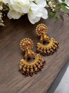 Shine like a glowing star in these high quality yellow gold look temple jewellery earrings lined with fine coloured stone beads. Pair them up with your silks and satins and add charm and charisma to your beautiful personality. Gorgeous studs with coloured stone beads available in multiple options. Highest quality and craftsmanship. Please contact us for any questions. Festival Chandbali Danglers For Pierced Ears, Round Earrings For Rituals And Festivals, Festival Earrings For Rituals, Festive Chandbalis For Navratri With Pierced Ears, Festive Navratri Chandbalis With Pierced Ears, Temple Jewelry Earrings With Latkans For Festivals, Fusion Style Earrings For Diwali Puja, Temple Style Chandbalis For Festivals, Fusion Chandbali Earrings For Puja