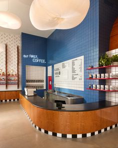 the interior of a deli with blue and white tiles on the walls, counters and shelves