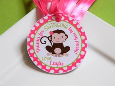 a pink and green tag with a monkey on it's side that says swinging my way, love laugh