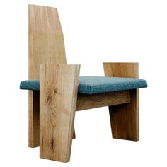 a wooden chair with a blue cushion on it's seat and backrests